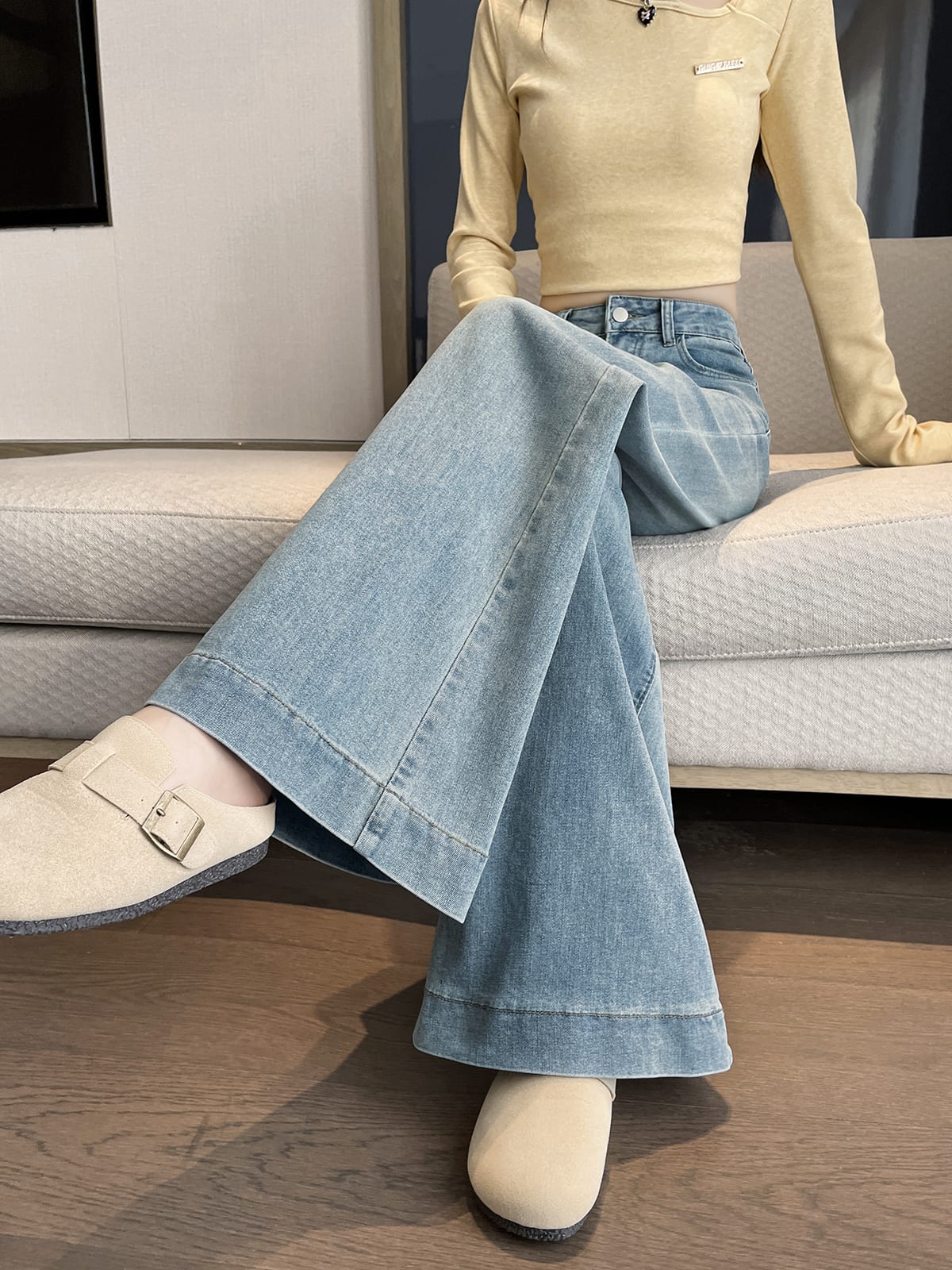 YEEYEEWang wide-leg jeans in light wash blue, Asian-fit cut, sitting studio pose.