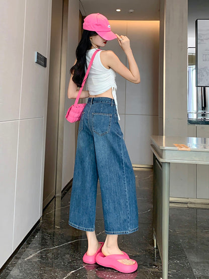 YEEYEEWang Wide-Leg Jeans in Vintage Blue, Asian-fit cut, full-body back view standing, back patch pockets visible, pink cap and crossbody bag.