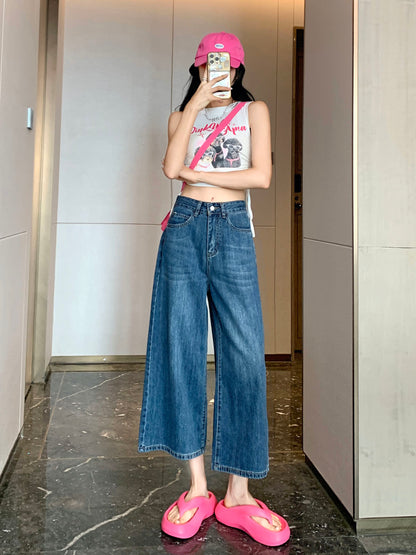 YEEYEEWang Wide-Leg Jeans in Vintage Blue, Asian-fit cut, full-body front pose holding phone at face, pink cap and white graphic tank top.