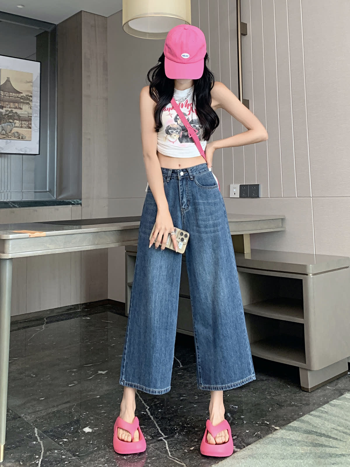 YEEYEEWang Wide-Leg Jeans in Vintage Blue, Asian-fit cut, full-body front standing pose with one hand on hip holding phone, pink cap and crossbody bag.
