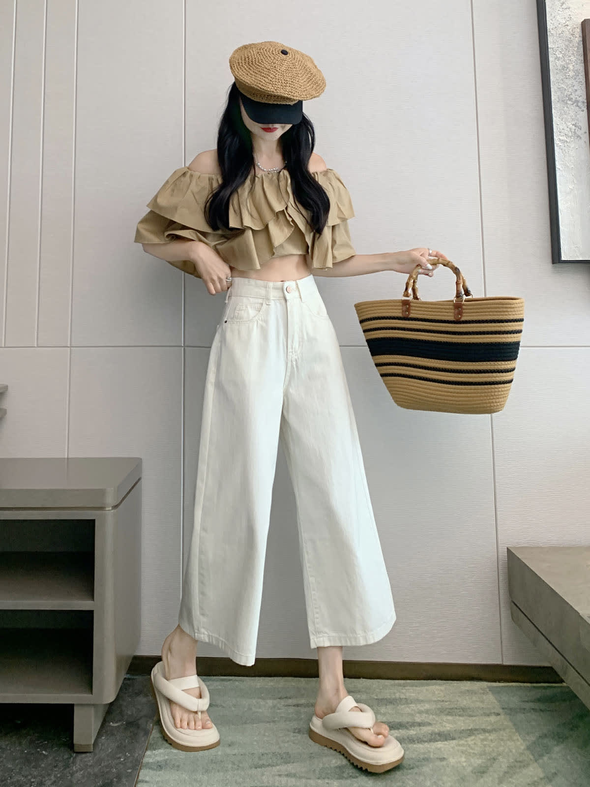YEEYEEWang Wide-Leg Jeans in Ivory, Asian-fit cut, full-body front standing pose holding straw tote raised, off-shoulder ruffle top and straw cap.