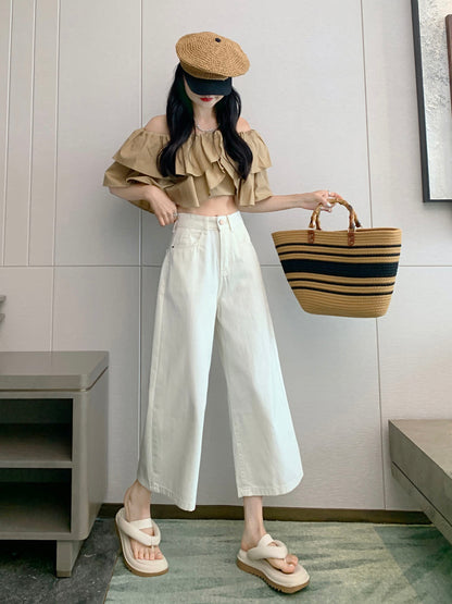 YEEYEEWang Wide-Leg Jeans in Ivory, Asian-fit cut, full-body front standing pose holding straw tote raised, off-shoulder ruffle top and straw cap.