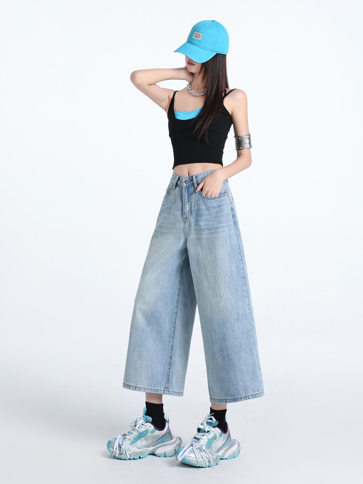 YEEYEEWang Wide-Leg Jeans in Light Blue, Asian-fit cut, full-body front pose with one hand in front pocket, other hand behind head, blue cap.