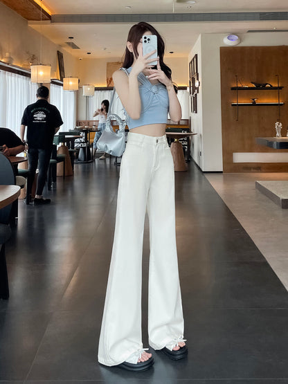 YEEYEEWang Flare Jeans in White, Asian-fit cut, full-body front view standing holding phone at face with silver shoulder bag in cafe.