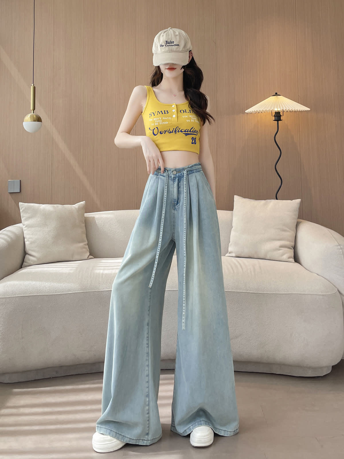 YEEYEEWang Wide-Leg Jeans in Light Blue, Asian-fit cut, full-body front standing pose in cap and yellow tank, drawstring hanging loose.