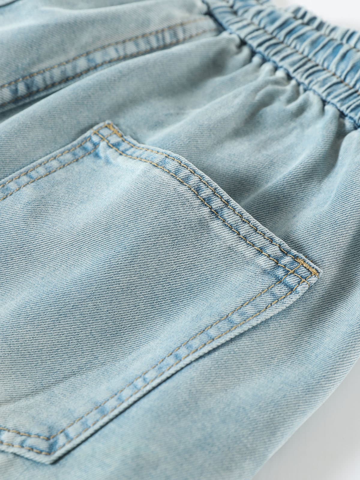 YEEYEEWang Wide-Leg Jeans in Light Blue, Asian-fit cut, close-up of back patch pocket with double topstitching under elastic waistband.