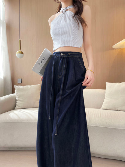 YEEYEEWang wide-leg jeans in Denim Blue, Asian-fit cut, half-body front pose holding a book at side, drawstring waist with silver button and pleated front detail.