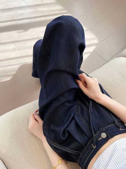 YEEYEEWang wide-leg jeans in Denim Blue, Asian-fit cut, close-up of hands lifting the wide leg fabric to show soft drape, contrast stitching and button detail visible.