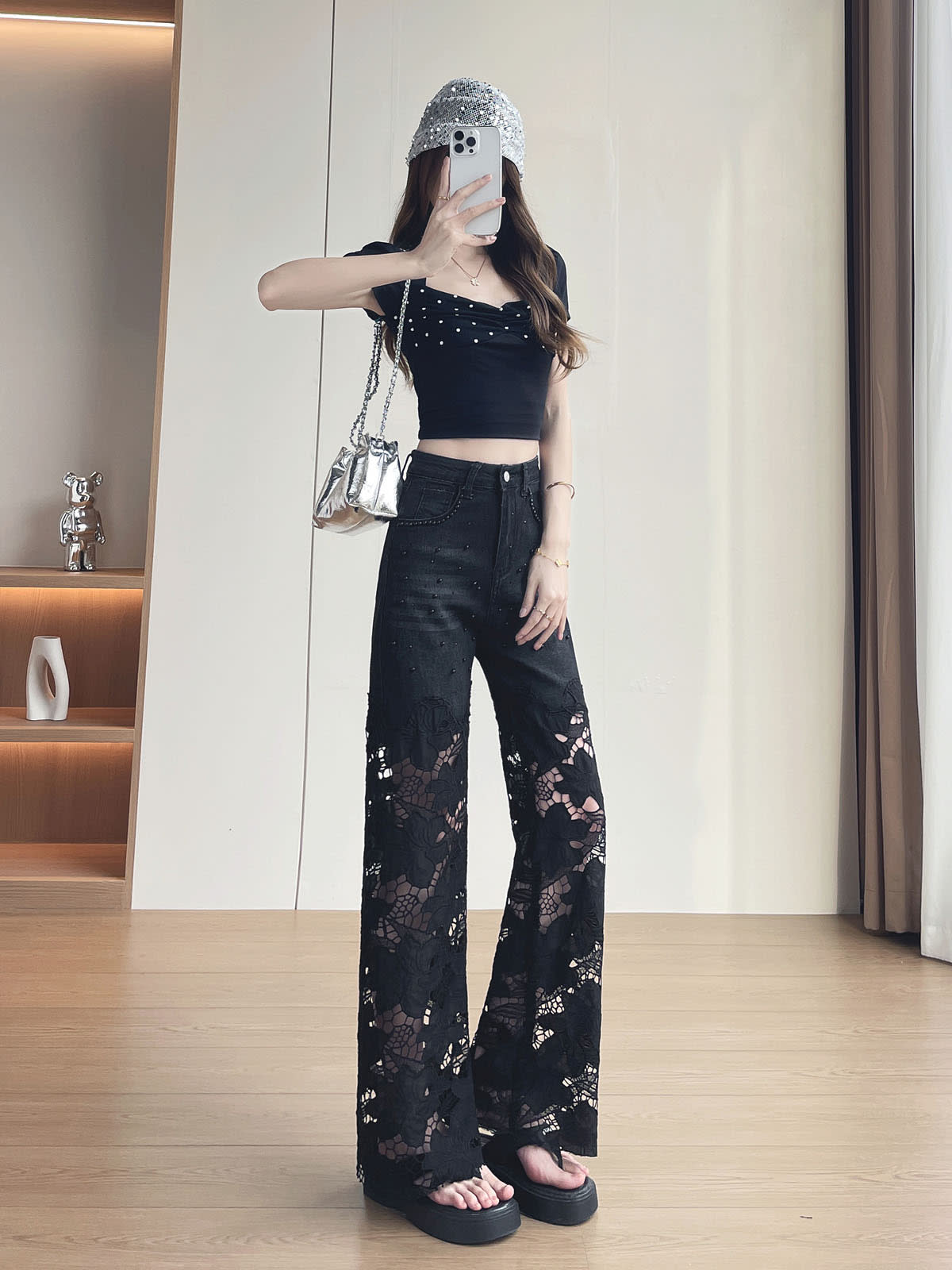 YEEYEEWang Wide-Leg Jeans in Solid Black, Asian-fit cut, full-body front pose holding phone at face, other hand on thigh, sequin bucket hat and silver bag.