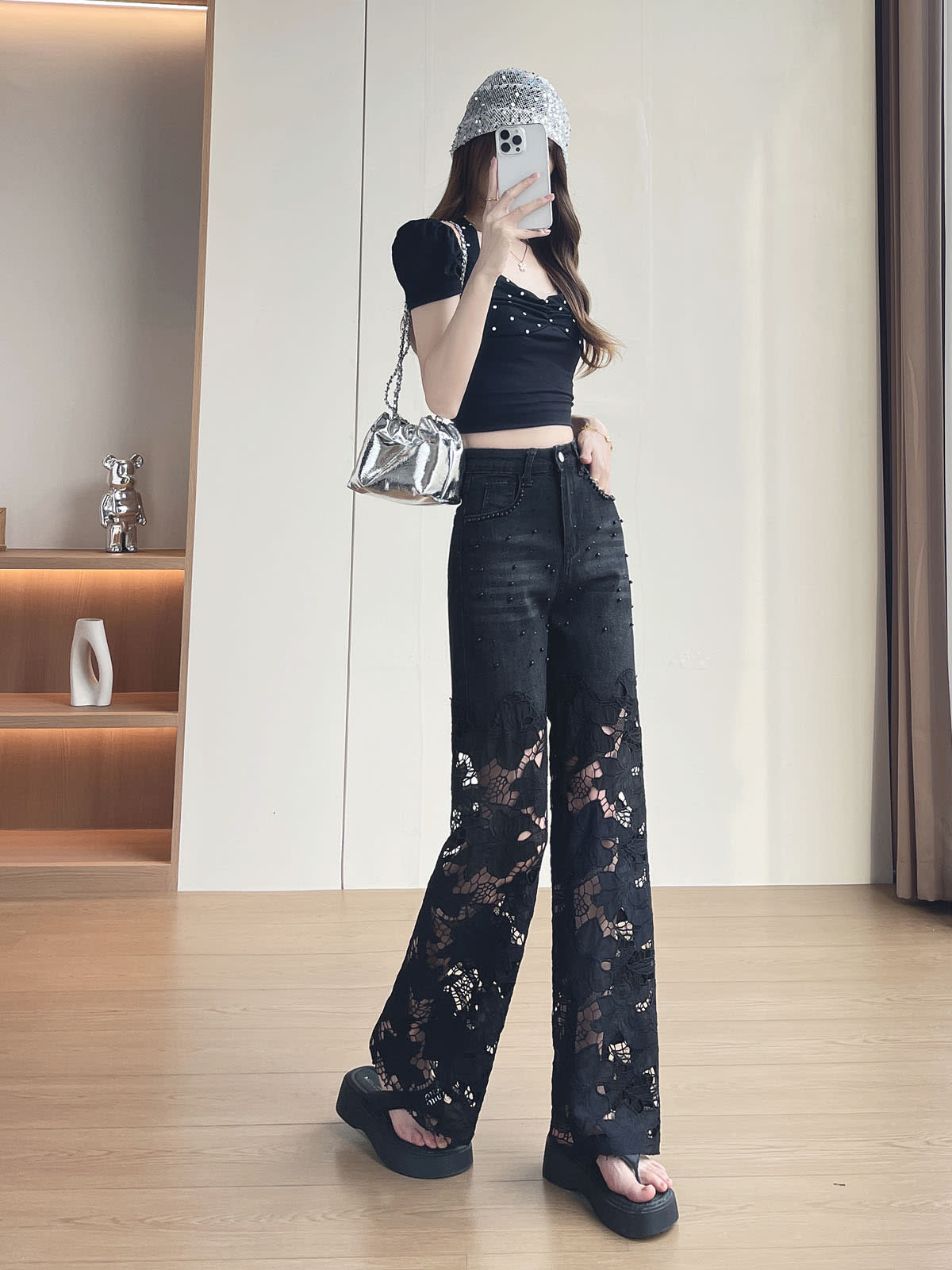 YEEYEEWang Wide-Leg Jeans in Solid Black, Asian-fit cut, full-body front pose holding phone at face, hand resting on waistband, sequin bucket hat and silver chain bag.