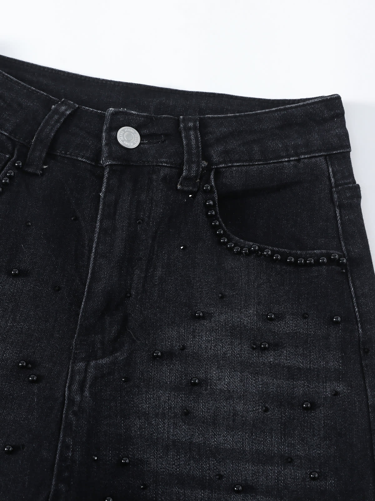 YEEYEEWang Wide-Leg Jeans in Solid Black, Asian-fit cut, close-up of waistband with metal button, belt loops and curved front pocket opening trimmed with stud embellishments.