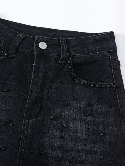 YEEYEEWang Wide-Leg Jeans in Solid Black, Asian-fit cut, close-up of waistband with metal button, belt loops and curved front pocket opening trimmed with stud embellishments.