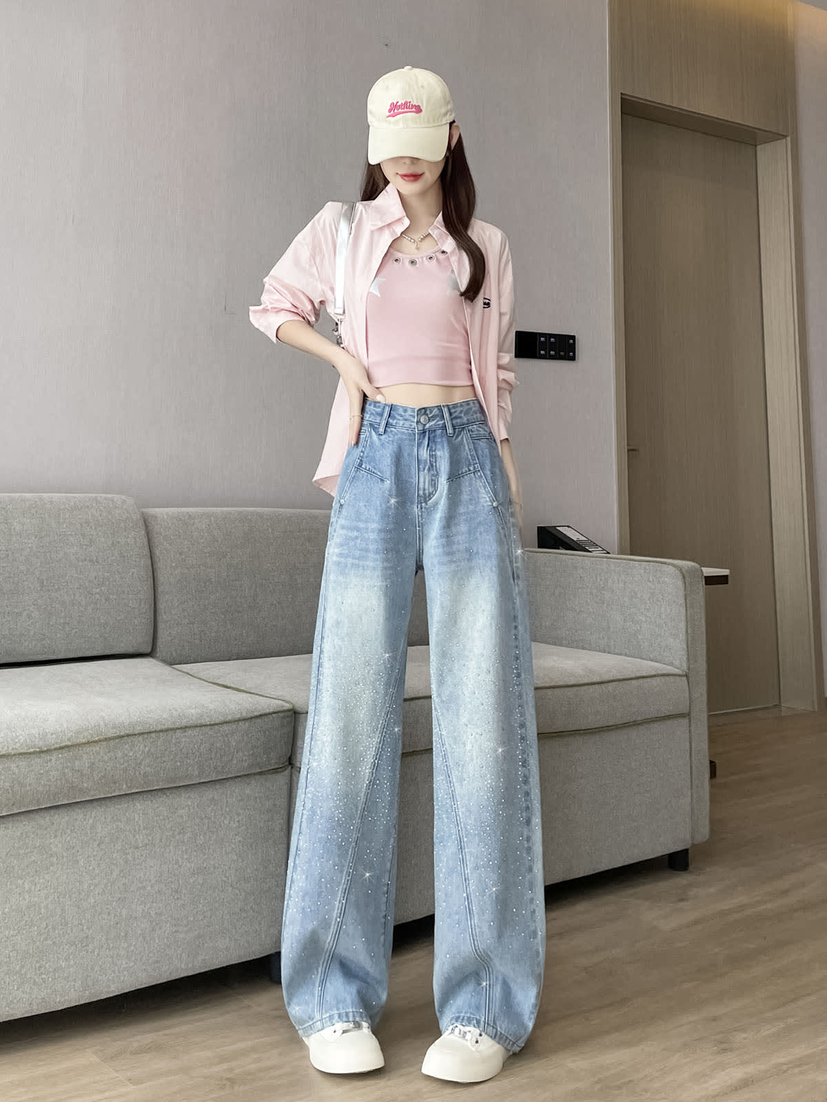 YEEYEEWang Wide-Leg Jeans in Light Blue, Asian-fit cut, full-body standing pose with hand resting on waistband, cream cap and pink shirt, rhinestone-embellished denim.