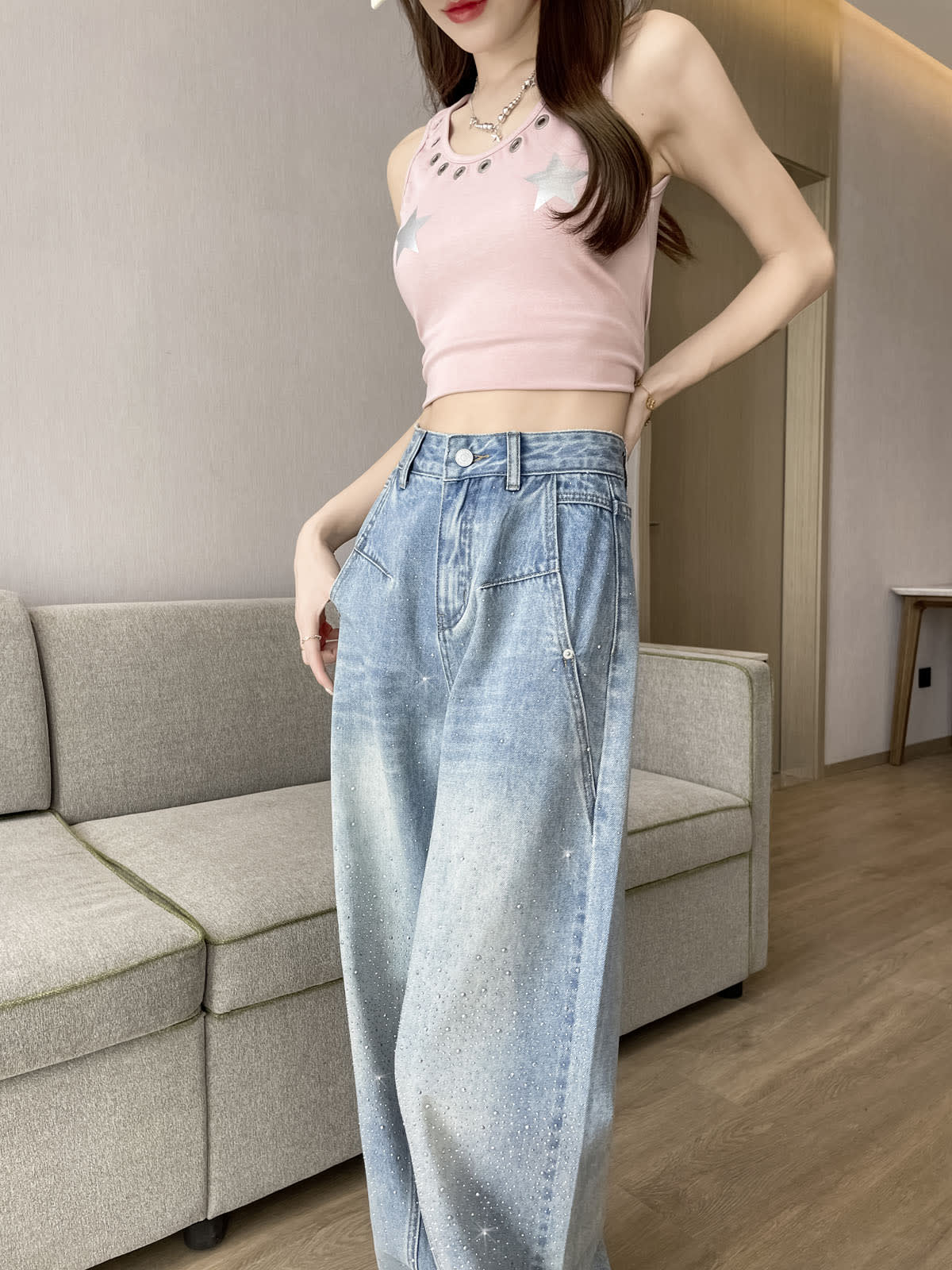 YEEYEEWang Wide-Leg Jeans in Light Blue, Asian-fit cut, half-body close view of high-rise waistband with silver-tone button, front pockets and scattered rhinestones.