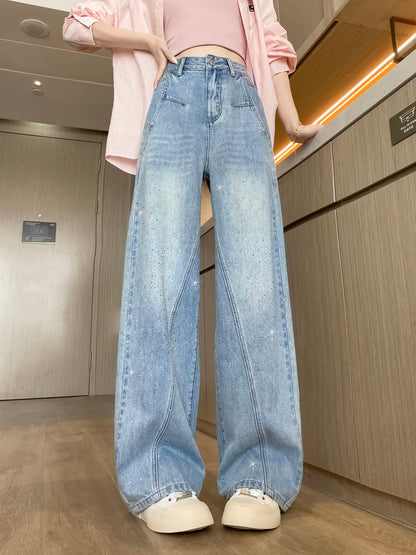 YEEYEEWang Wide-Leg Jeans in Light Blue, Asian-fit cut, waist-down front standing pose, hand resting on waistband, pink shirt layered over top, rhinestone-scattered legs.