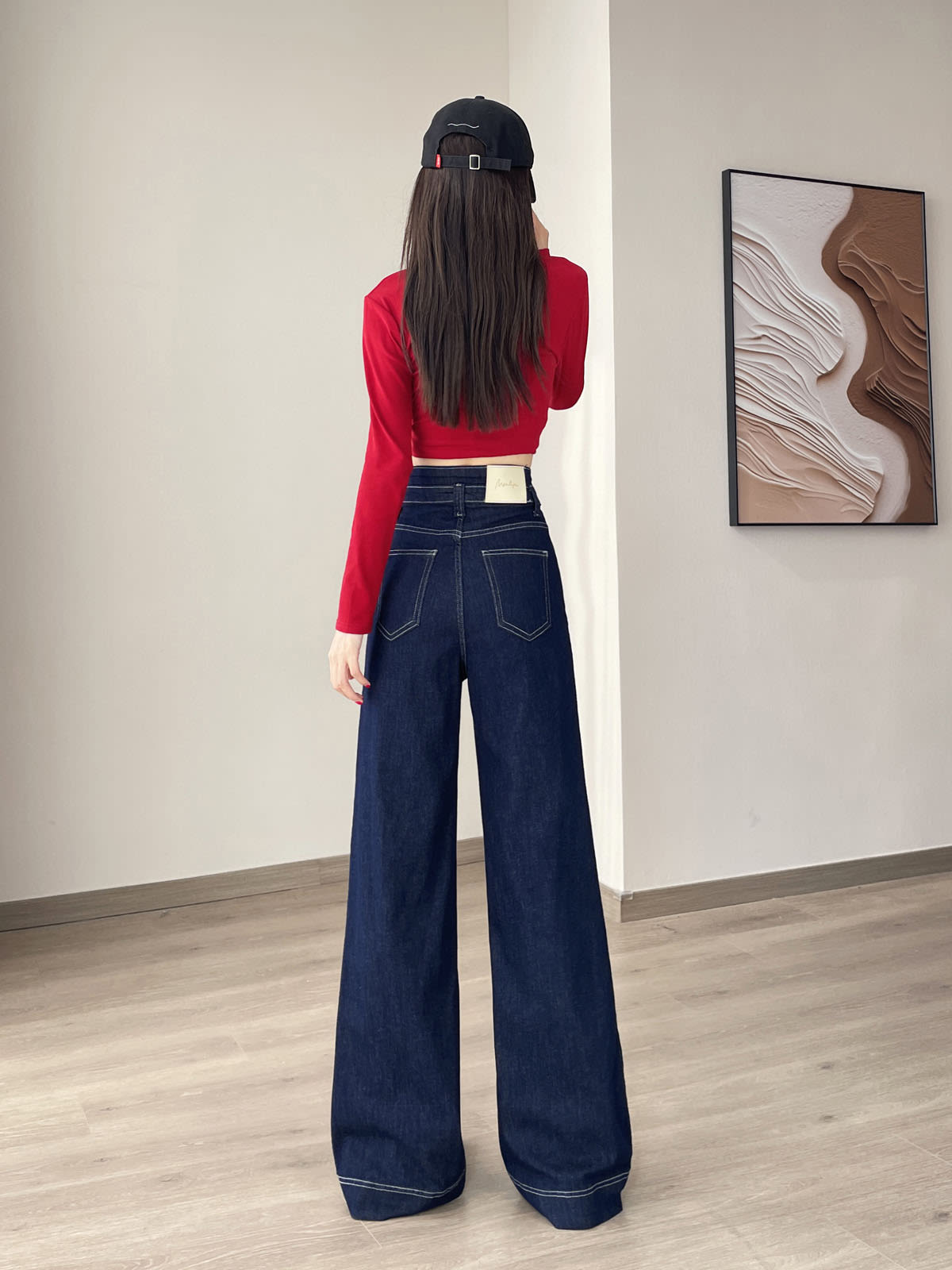 YEEYEEWang Wide-Leg jeans in Denim Blue, Asian-fit cut, full-body back view showing back patch pockets and leather patch, black cap.