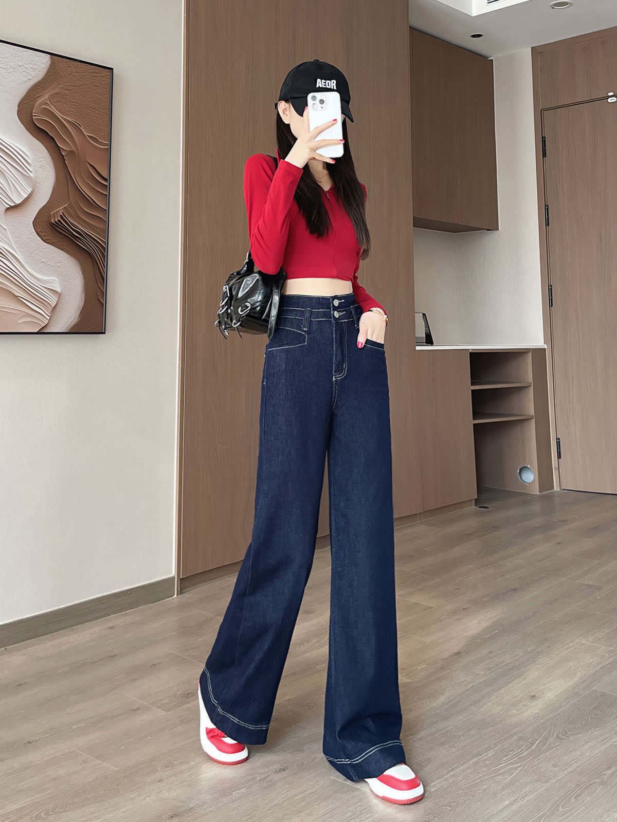 YEEYEEWang Wide-Leg jeans in Denim Blue, Asian-fit cut, full-body front pose holding phone at face, one hand in pocket, black bag.