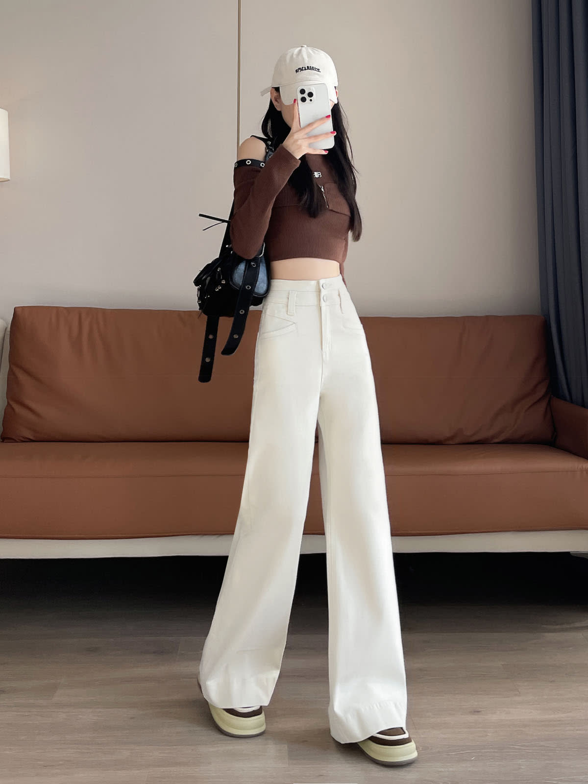 YEEYEEWang Wide-Leg jeans in Ivory, Asian-fit cut, full-body front pose holding phone at face, one hand in pocket, black bag.