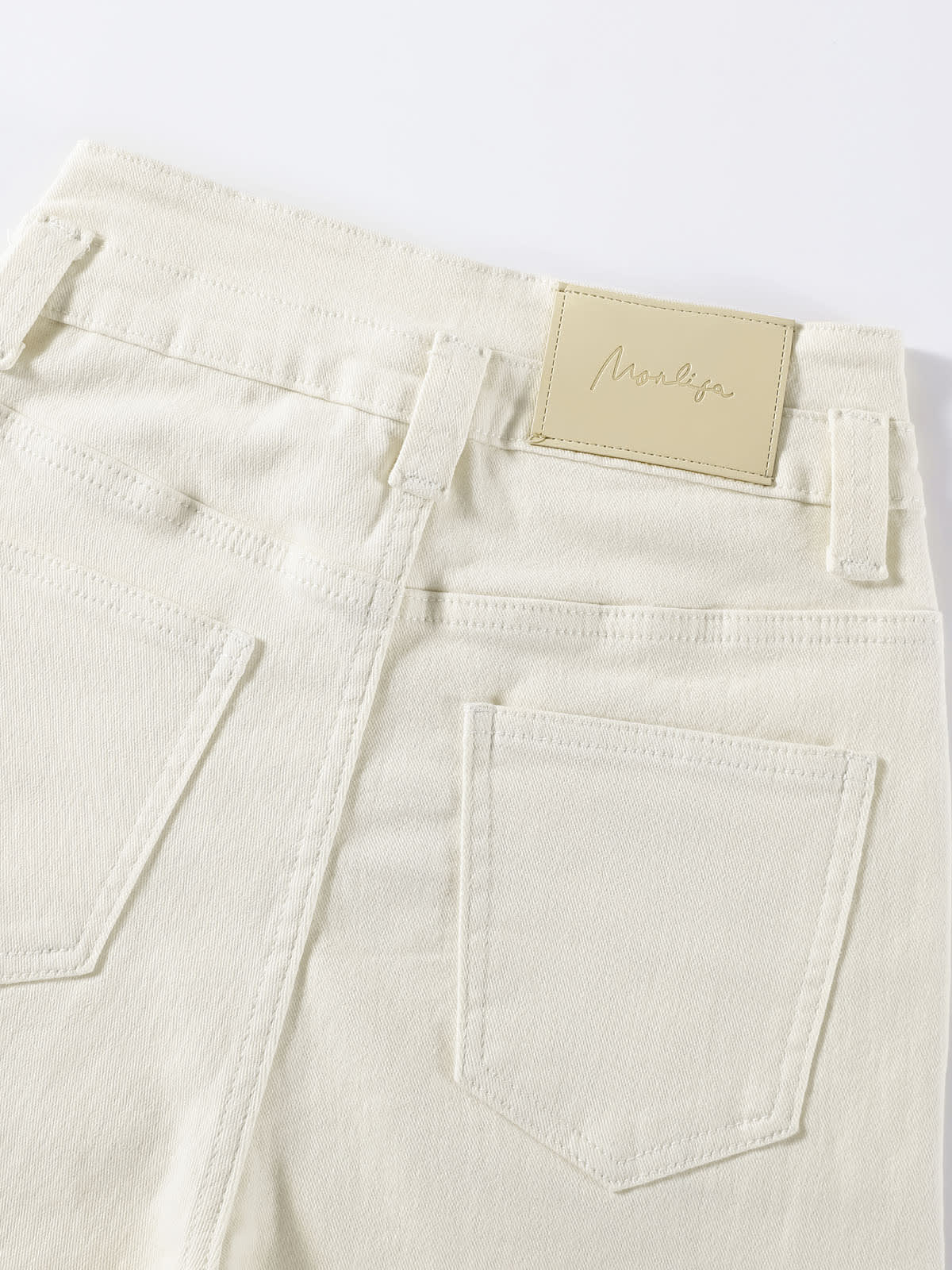 YEEYEEWang Wide-Leg jeans in Ivory, Asian-fit cut, close-up of back patch pockets with tonal stitching and leather patch.
