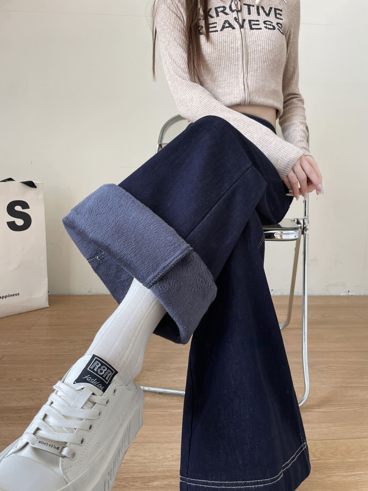 YEEYEEWang Wide-Leg Jeans in Denim Blue, Fleece-Lined, Asian-fit cut, waist-down seated pose showing rolled-up hem with fleece lining inside, variant thumbnail.