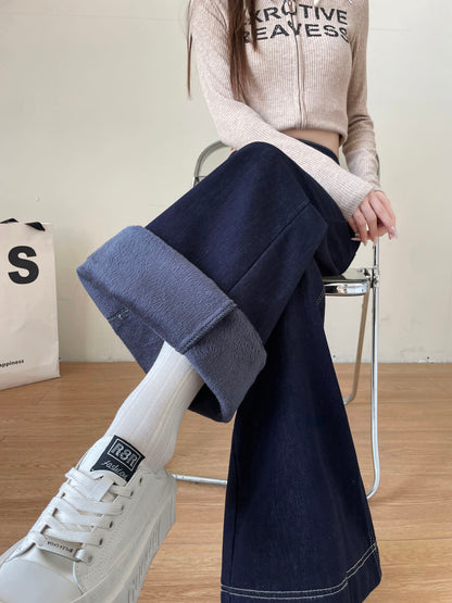 YEEYEEWang Wide-Leg Jeans in Denim Blue, Fleece-Lined, Asian-fit cut, waist-down seated pose showing rolled-up hem with fleece lining inside, variant thumbnail.