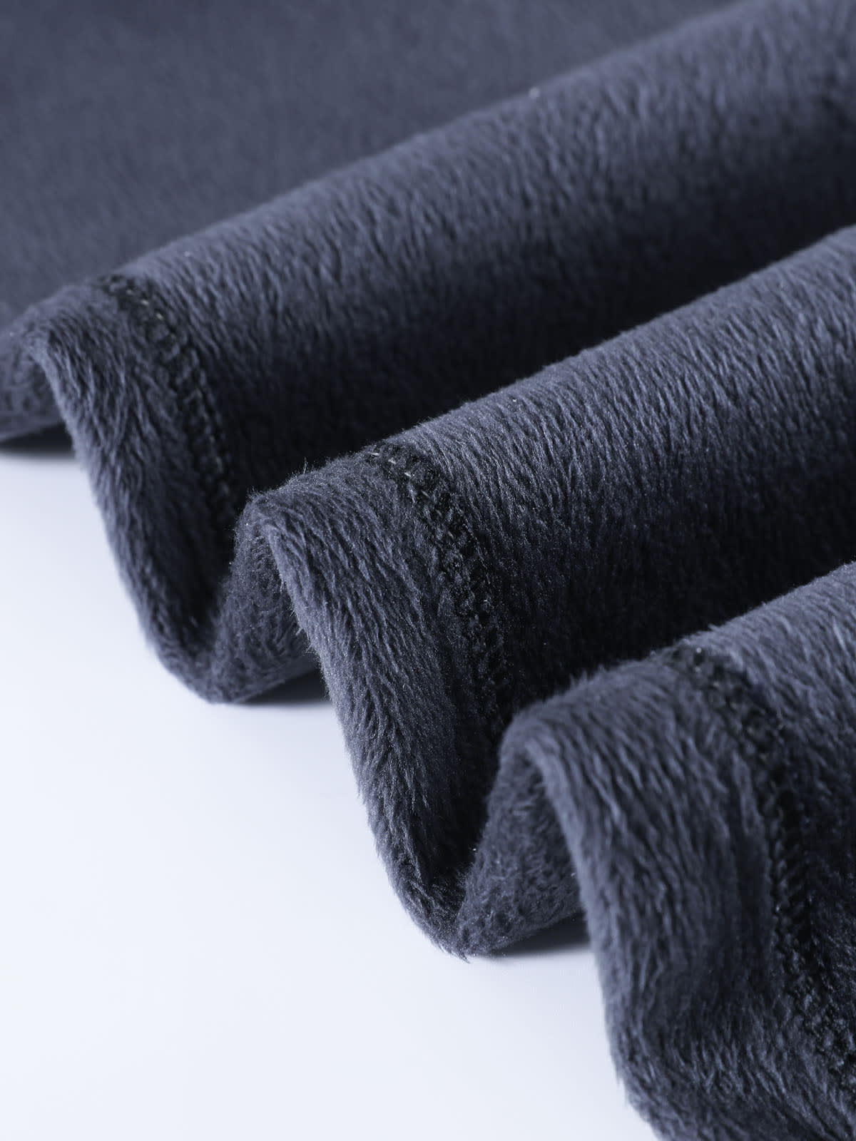 YEEYEEWang Wide-Leg Jeans in Denim Blue, Fleece-Lined, Asian-fit cut, close-up of draped fleece lining folds showing dense fluffy inner texture.