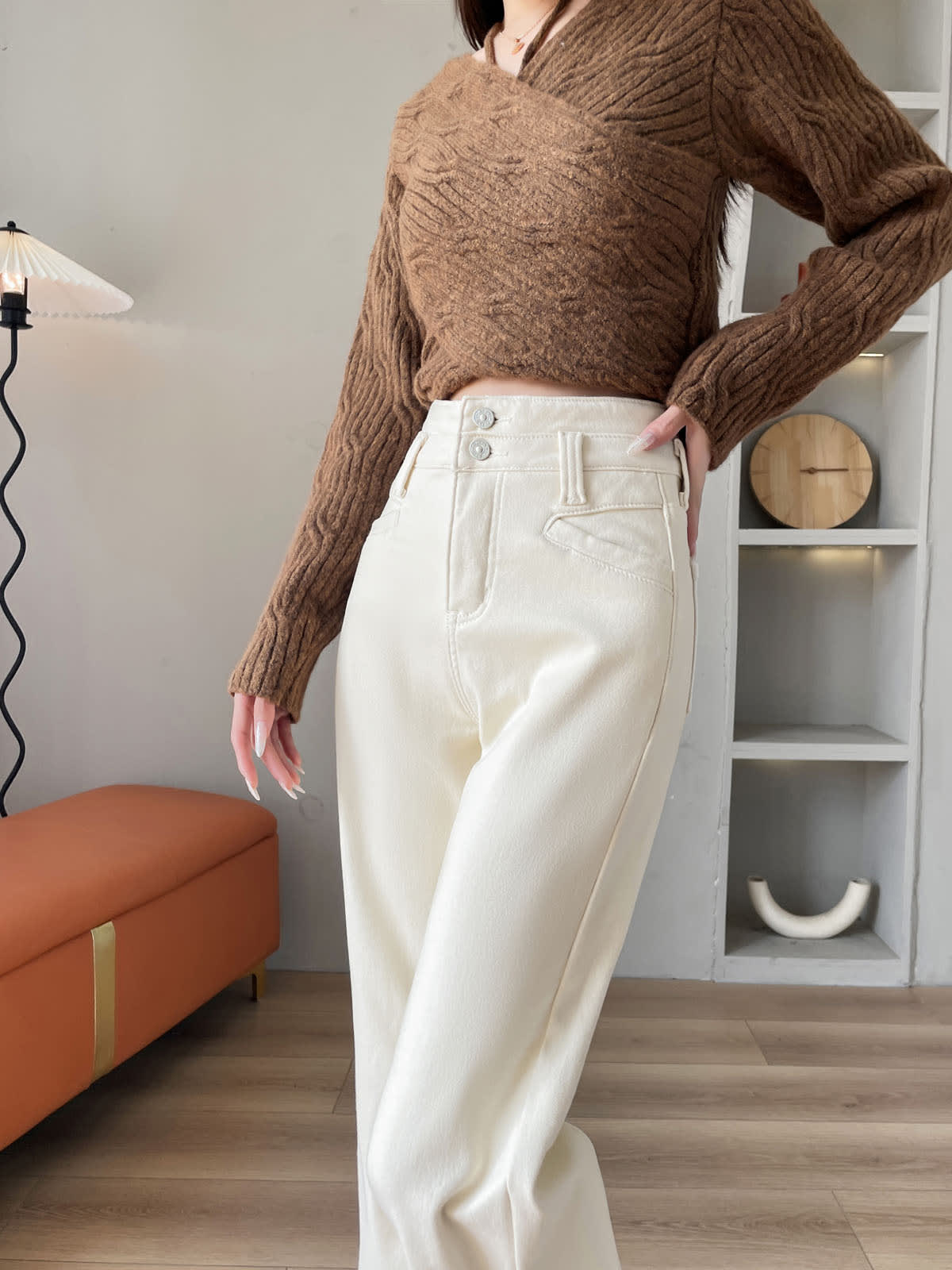 YEEYEEWang Wide-Leg Jeans in Ivory, Fleece-Lined, Asian-fit cut, waist-down front pose with one hand resting on the waistband, silver-tone double buttons on high waistband.