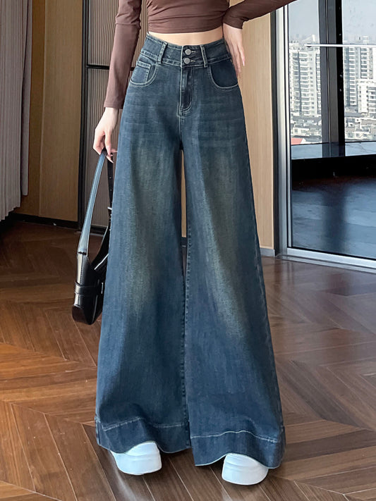 YEEYEEWang wide-leg jeans in Mid-Wash Blue, Asian-fit cut, waist-down front view holding black handbag, cuffed hems over white sneakers, variant thumbnail.