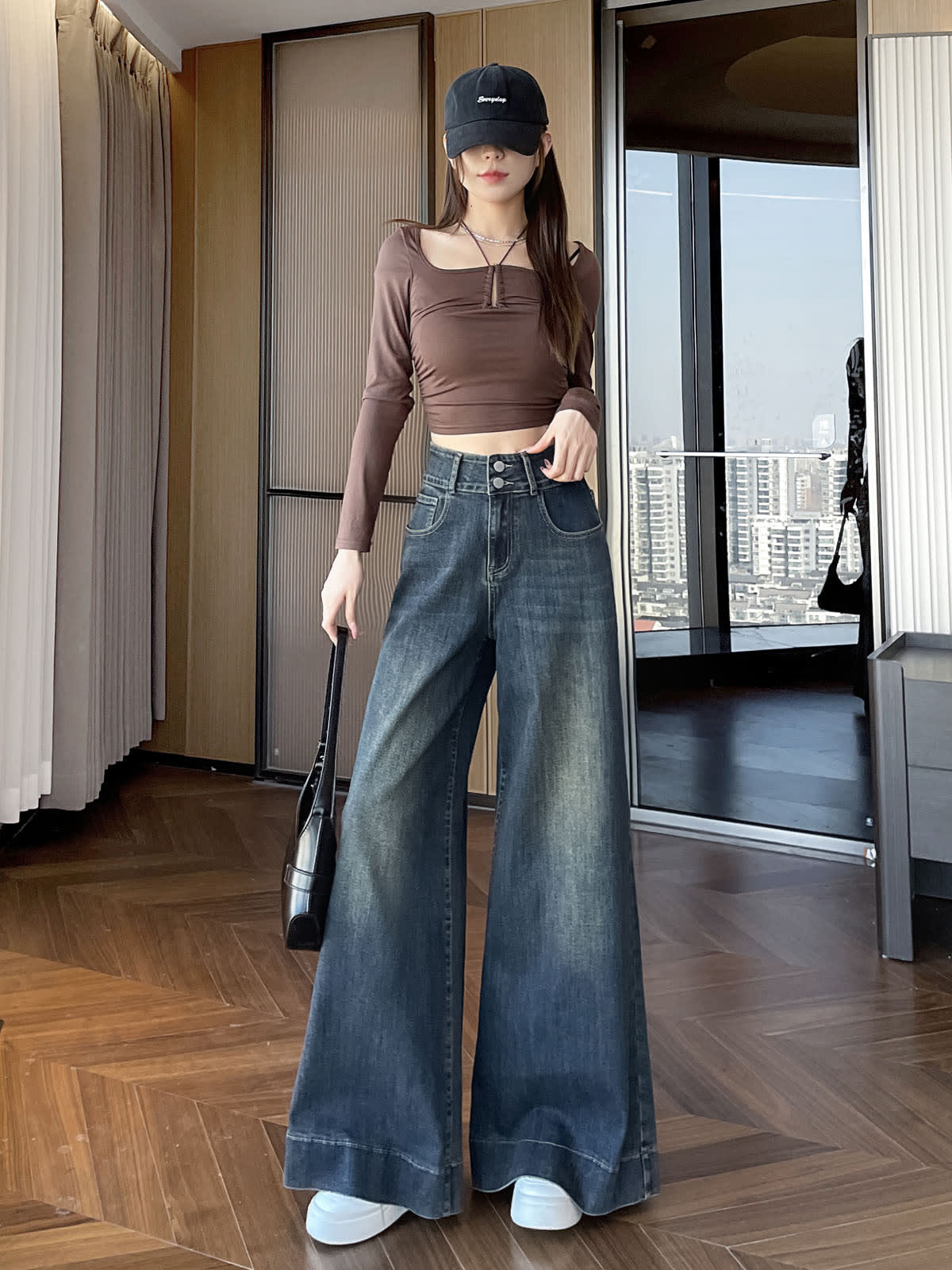 YEEYEEWang wide-leg jeans in Mid-Wash Blue, Asian-fit cut, full-body standing front pose in black cap and brown top, holding black handbag.