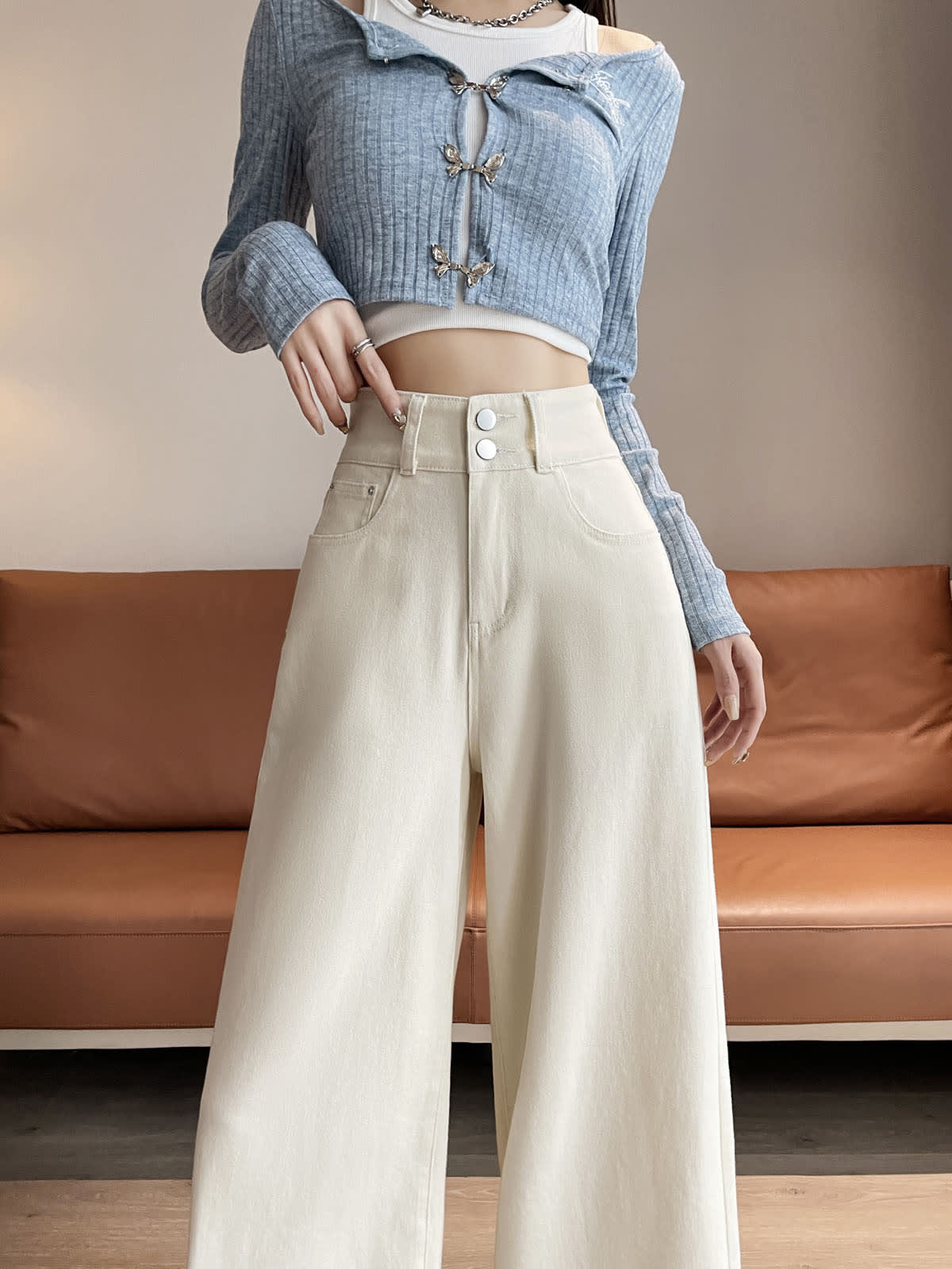 YEEYEEWang wide-leg jeans in Ivory, Asian-fit cut, waist-down standing front pose in blue cardigan, hand resting on double-button waistband.