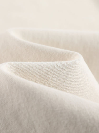 YEEYEEWang wide-leg jeans in Ivory, Asian-fit cut, close-up of soft cream denim texture with gentle folds and fine twill weave.