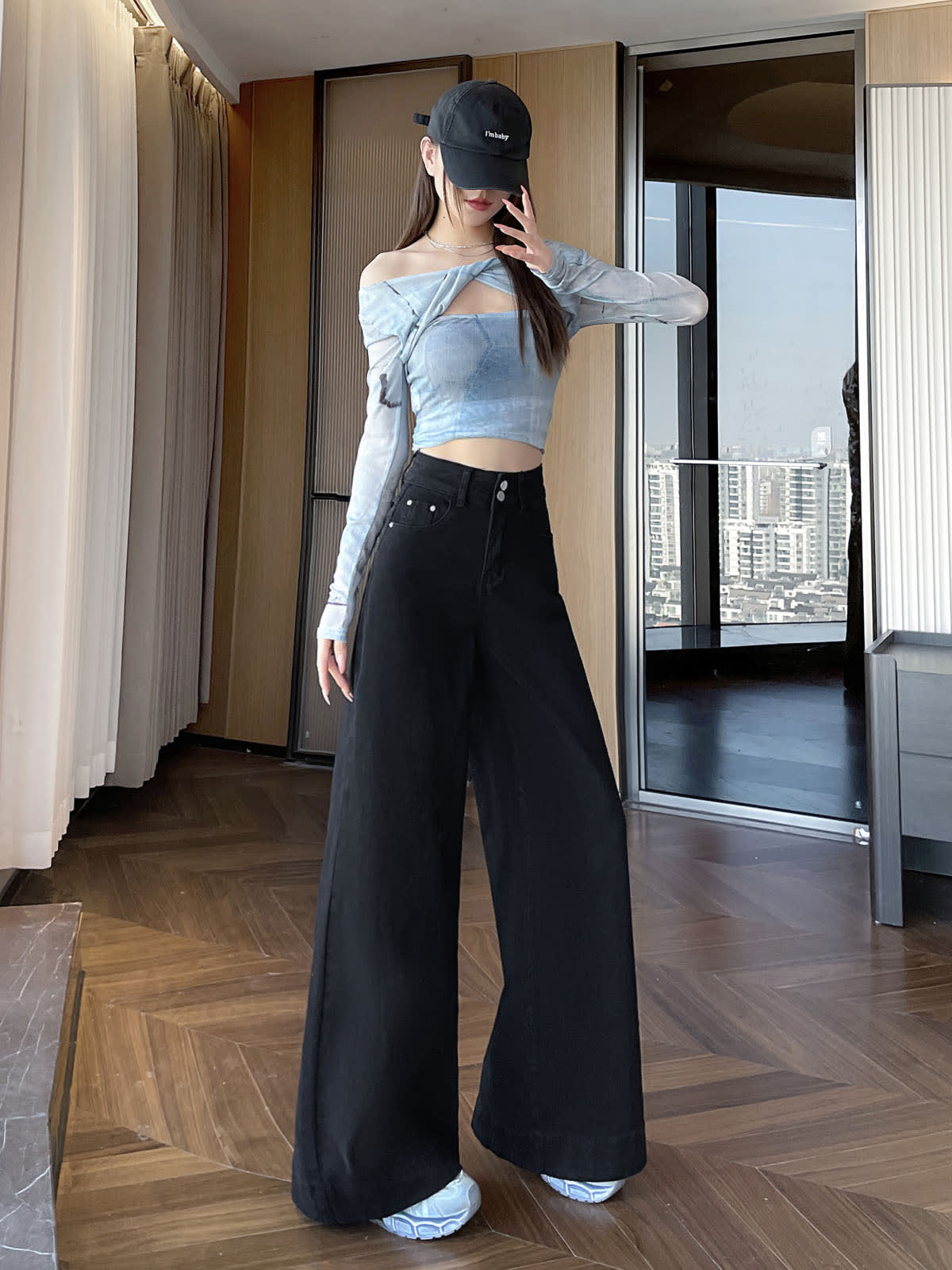 YEEYEEWang wide-leg jeans in Solid Black, Asian-fit cut, full-body standing front pose in black cap, one hand raised near face.