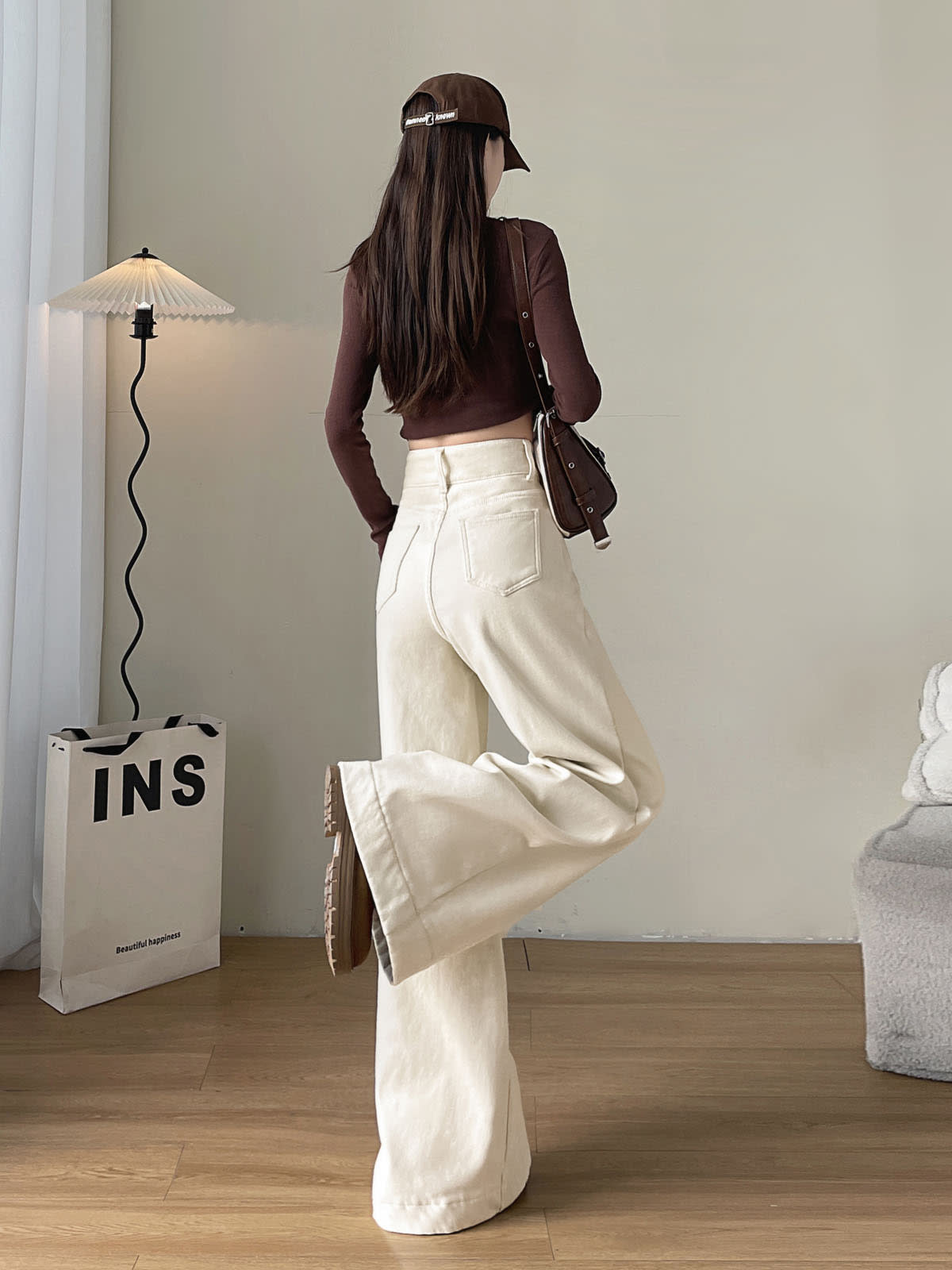 YEEYEEWang Fleece-Lined Wide-Leg Jeans in Ivory, full-body back view with leg-kick pose, brown crop top and shoulder bag, Asian-fit cut.