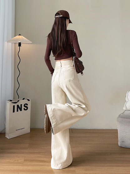 YEEYEEWang Fleece-Lined Wide-Leg Jeans in Ivory, full-body back view with leg-kick pose, brown crop top and shoulder bag, Asian-fit cut.