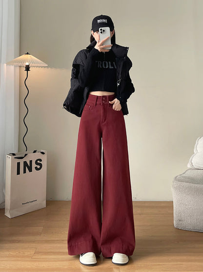YEEYEEWang Fleece-Lined Wide-Leg Jeans in Dark Cherry, full-body front standing view holding phone at face, black puffer jacket and cap, Asian-fit cut.