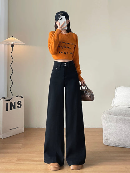 YEEYEEWang Fleece-Lined Wide-Leg Jeans in Solid Black, full-body front standing view holding phone at face and brown handbag, orange letter-print sweater, Asian-fit cut.
