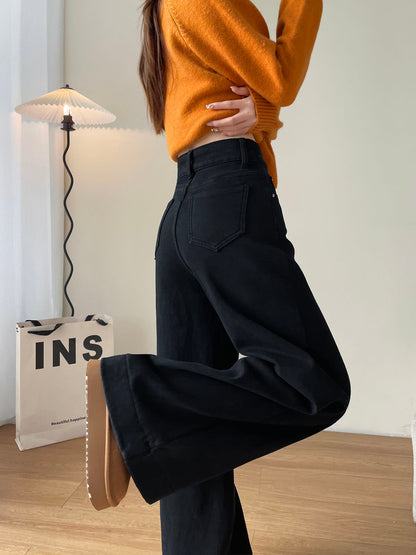 YEEYEEWang Fleece-Lined Wide-Leg Jeans in Solid Black, half-body back view with leg-kick pose, pointed back patch pocket, orange sweater, Asian-fit cut.