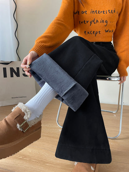 YEEYEEWang Fleece-Lined Wide-Leg Jeans in Solid Black, waist-down seated pose on chair, hand holding folded cuff showing fleece lining over white socks, Asian-fit cut.