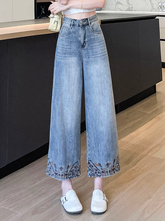 YEEYEEWang Wide-Leg Jeans in Light Blue, Asian-fit cut, waist-down standing pose showing high waist and paisley-embroidered hems with white buckle mules, variant thumbnail.