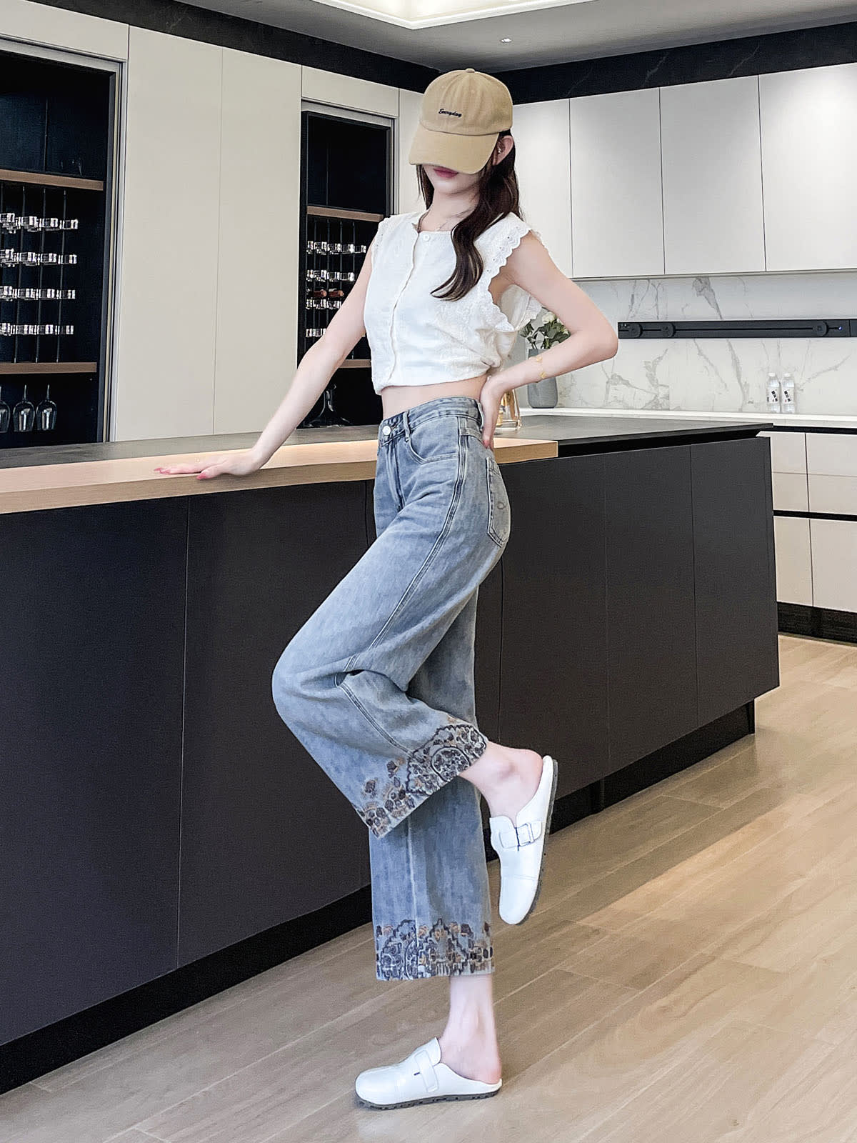 YEEYEEWang Wide-Leg Jeans in Light Blue, Asian-fit cut, full-body side pose leaning on counter with one leg kicked back, hand resting on waistband.