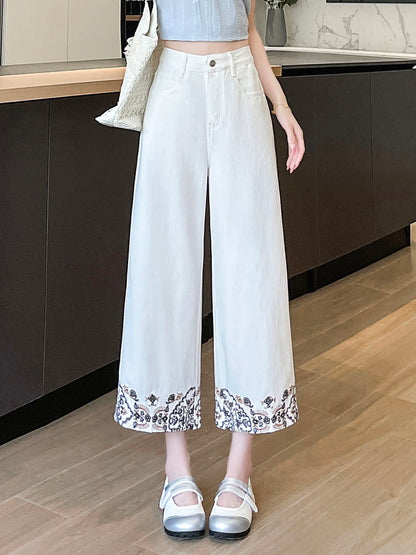 YEEYEEWang Wide-Leg Jeans in Ivory, Asian-fit cut, waist-down front standing view showing high waistband and floral embroidered hems, variant thumbnail.