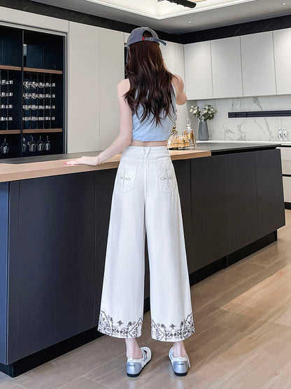 YEEYEEWang Wide-Leg Jeans in Ivory, Asian-fit cut, full-body back view standing, back patch pockets with floral stitching and embroidered hems.