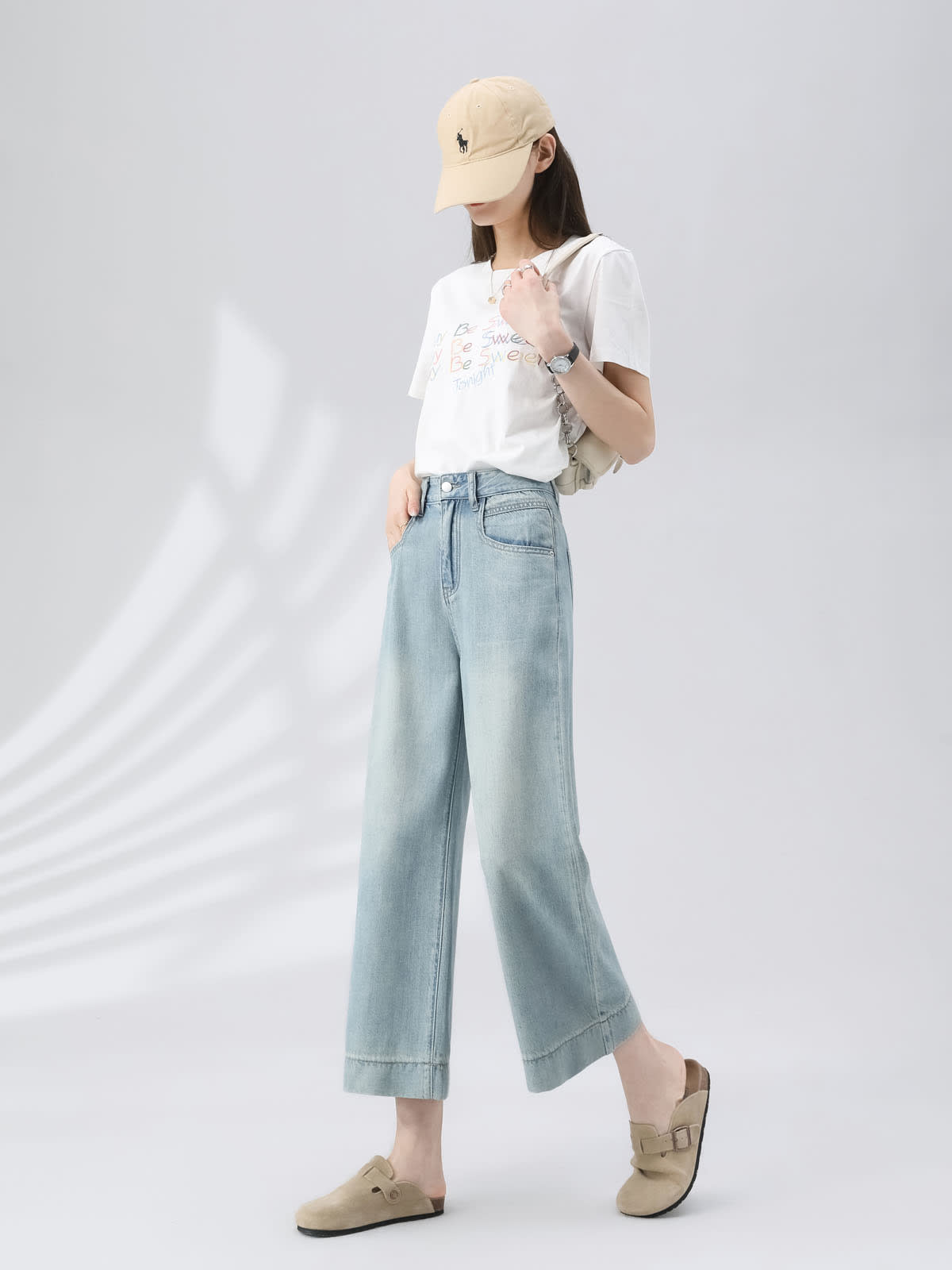 YEEYEEWang Wide-Leg Jeans in Light Blue, Asian-fit cut, full-body side view walking with one hand in front pocket, beige cap and white graphic tee.