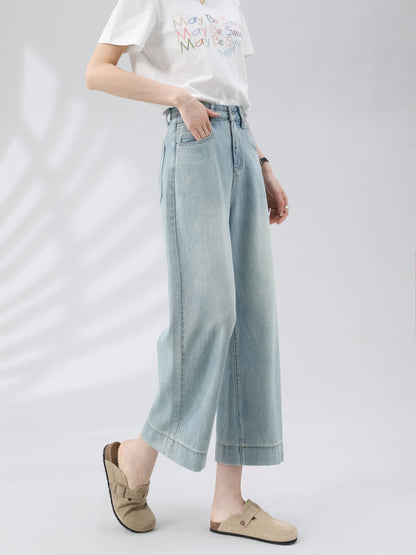 YEEYEEWang Wide-Leg Jeans in Light Blue, Asian-fit cut, waist-down side view walking with hand in front pocket, white graphic tee, wide stitched hems.