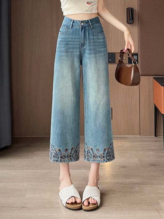 YEEYEEWang Straight Jeans in Vintage Blue, Asian-fit cut, waist-down front standing view holding a brown handbag, floral-embroidered hems, variant thumbnail.