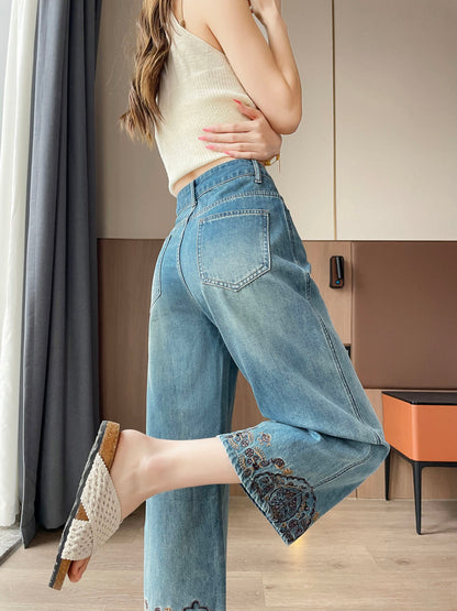 YEEYEEWang Straight Jeans in Vintage Blue, Asian-fit cut, waist-down back view with back patch pockets, one leg raised showing embroidered hem.