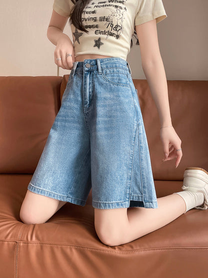 YEEYEEWang Denim Bermuda Shorts in Blue, Asian-fit cut, waist-down front view kneeling on a leather sofa, showing the relaxed wide-leg drape.