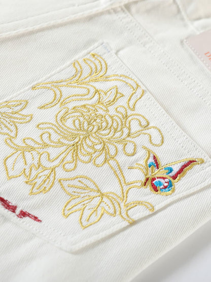 YEEYEEWang Denim Bermuda Shorts in White, Asian-fit cut, close-up of back patch pocket with floral and butterfly embroidery.