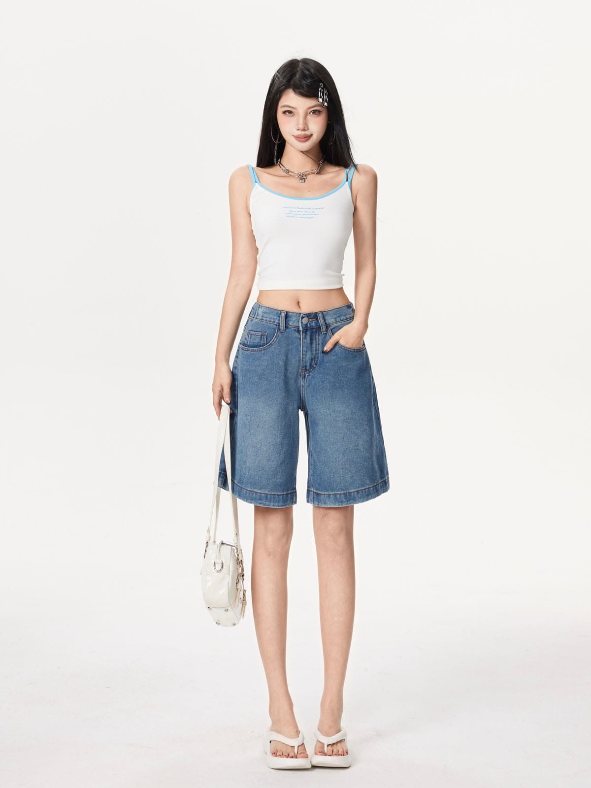 YEEYEEWang Denim Bermuda Shorts in Blue, Asian-fit cut, full-body front standing pose holding a white handbag, paired with white camisole and platform sandals.