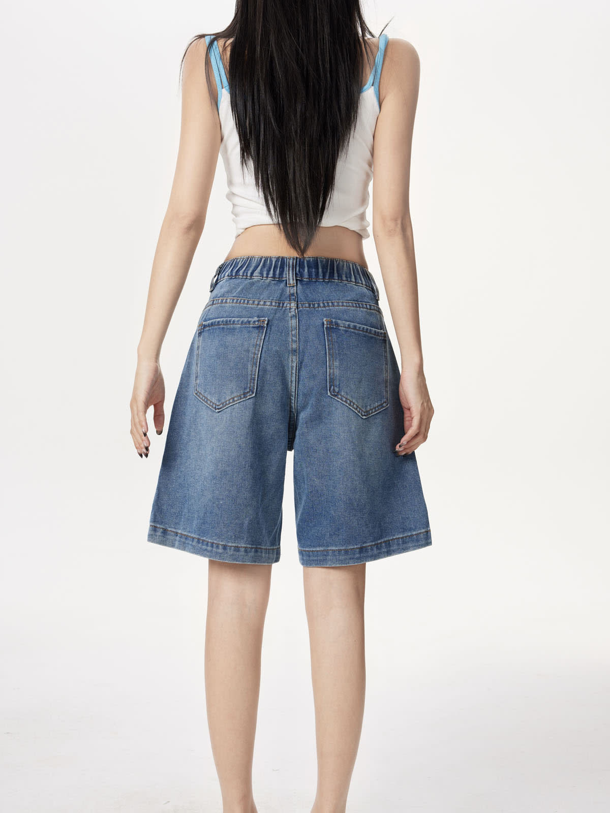 YEEYEEWang Denim Bermuda Shorts in Blue, Asian-fit cut, waist-down back standing view showing twin back patch pockets and gathered elastic-back waistband.